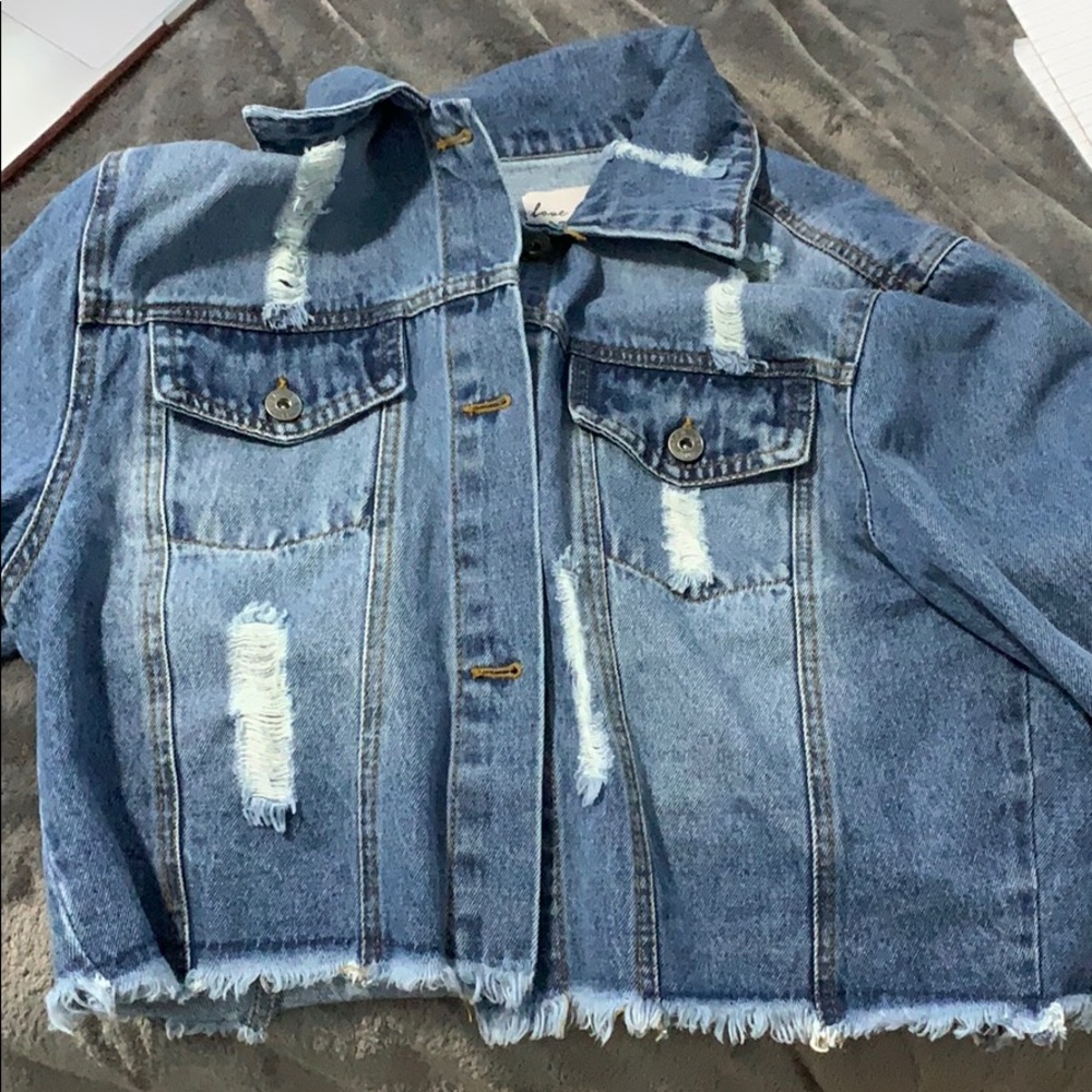 Medium wash cropped ripped denim jacket